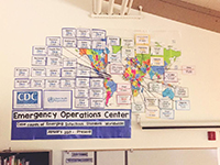 sarah-sletten A CDC Emergency Operations Center educational resources hangs on a white board.