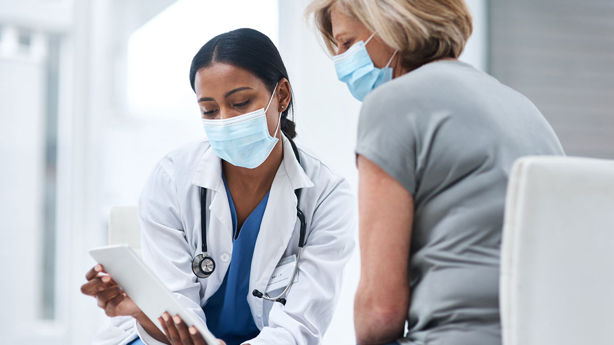 doctor & adult patient Doctor speaking to adult patient about shingles vaccine.