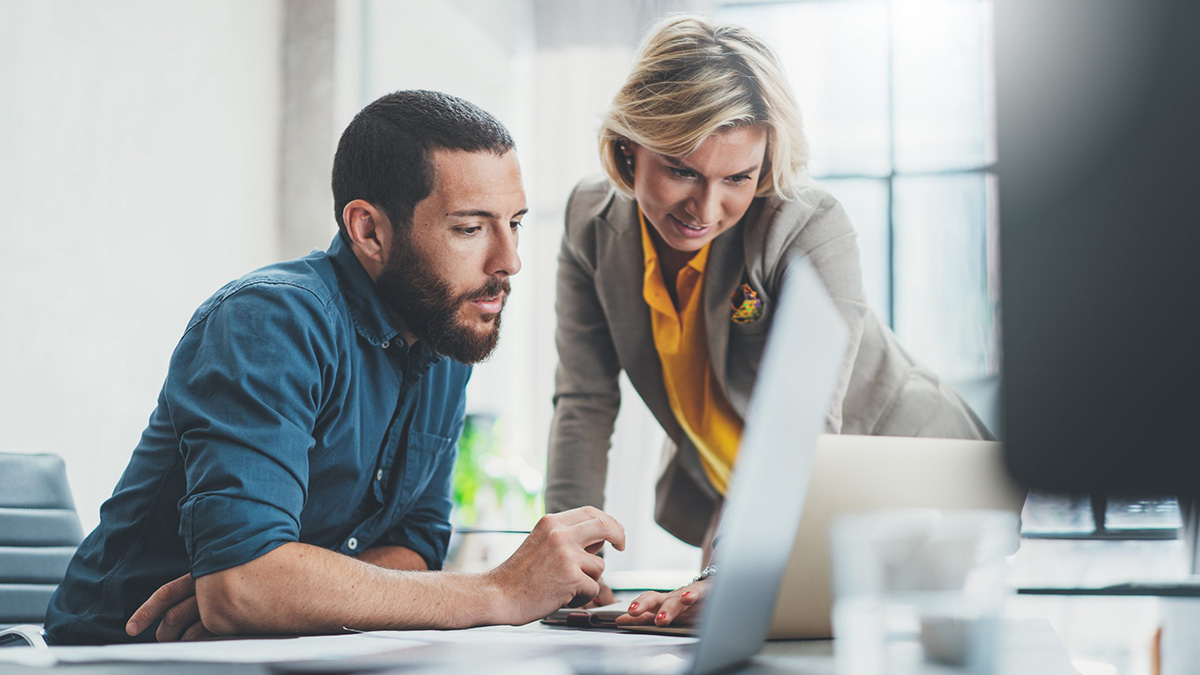 Man and woman looking at laptop screen. Man and woman looking at laptop screen