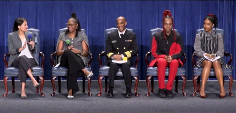 HHS SCD Summit Five persons sit in chairs on a stage