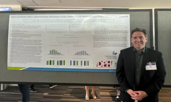 James Marton at Project RISE A person stands in front of a conference poster