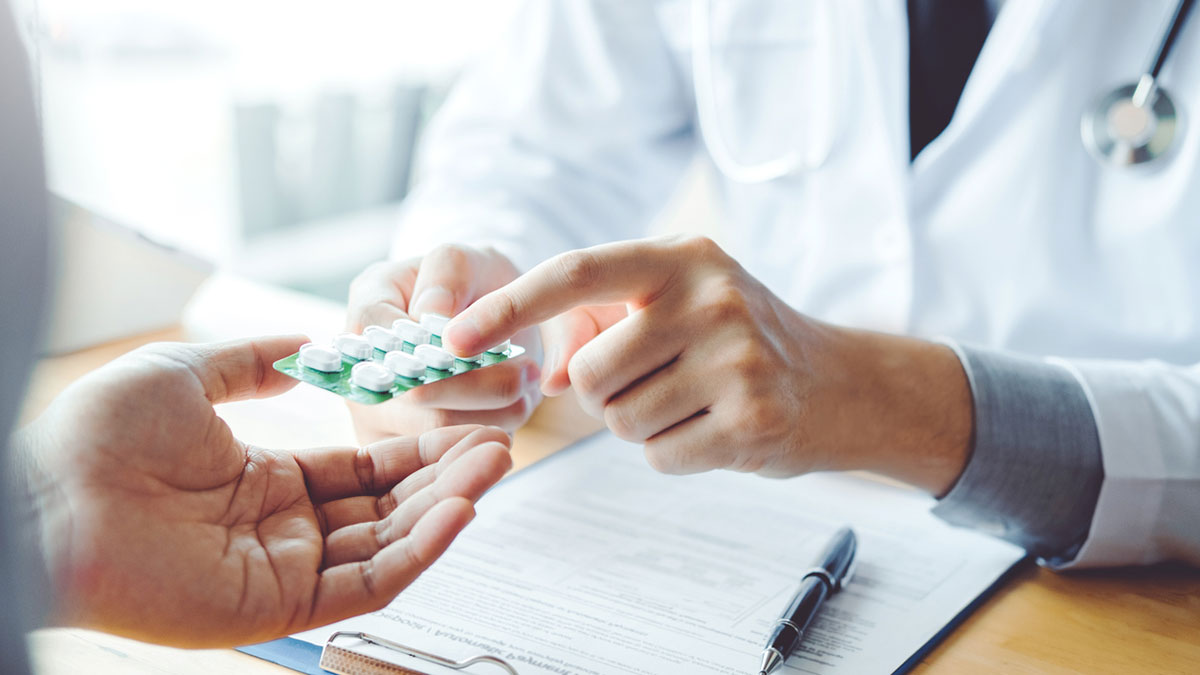 — title missing — A doctor giving prescription medication to patient