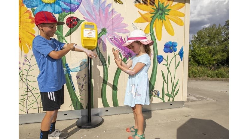 Nevada Sunscreen Kyle Davis and Hayley Davis apply sunscreen from a dispenser at a City of Reno park