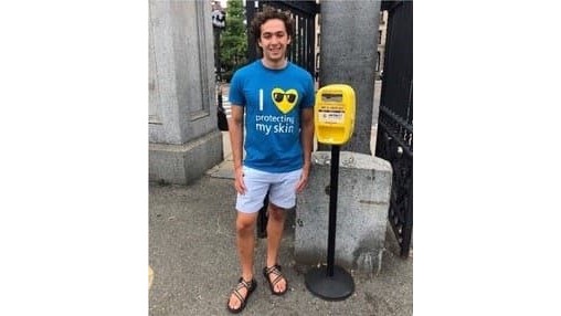 Vermont J Speyer Joshua Sims Speyer standing next to a sunscreen dispenser