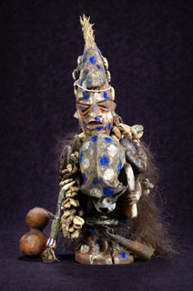 Shapona A statue with blue and gold colors, representing the West African god of smallpox.