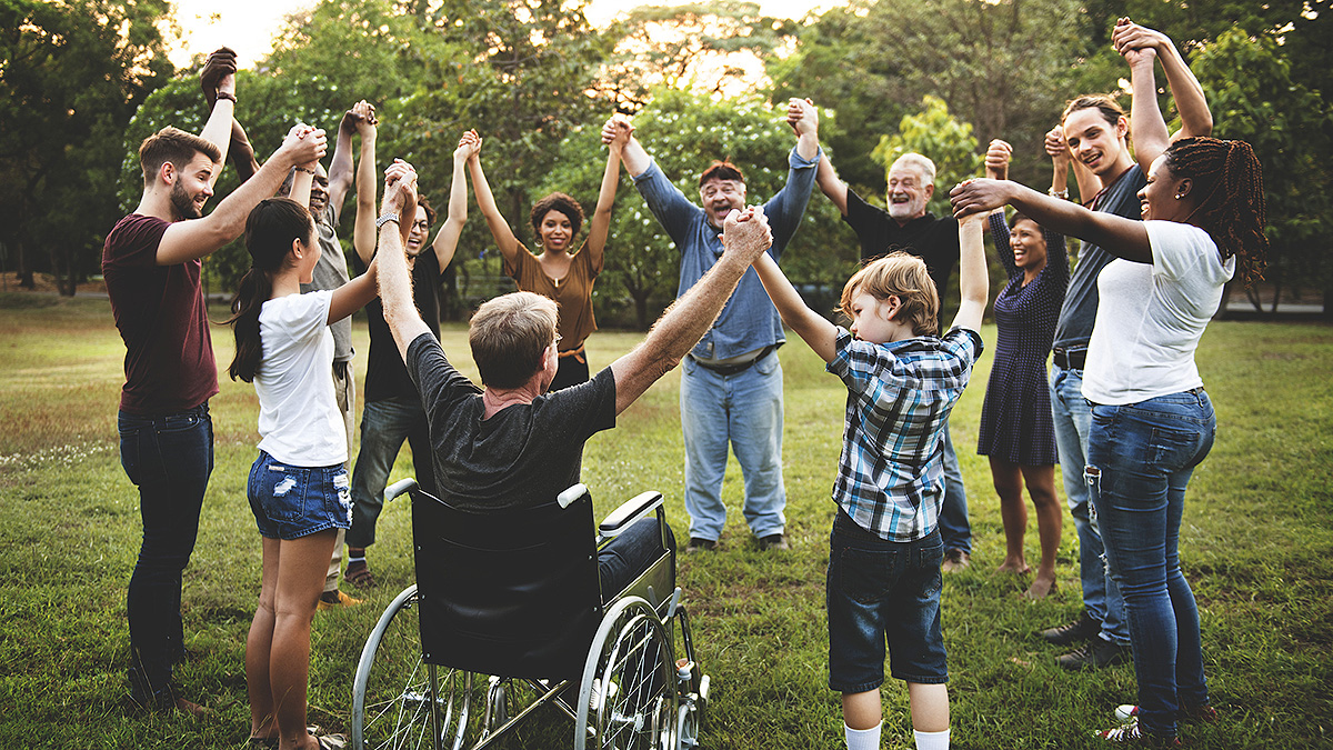 Diverse Group Cheer Diverse group outdoors, joined hands overhead, cheering outdoors.
