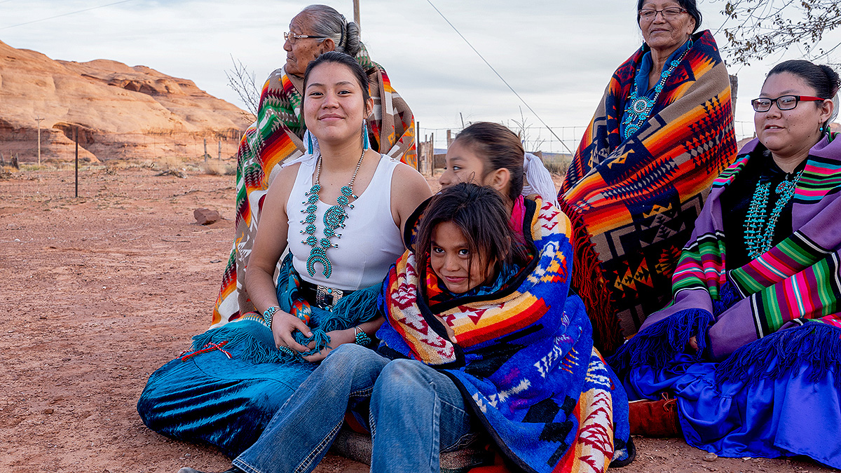 Female Navajo Family Multiple generations of female Navajos together, wrapped in customary blankets in Monument Valley.