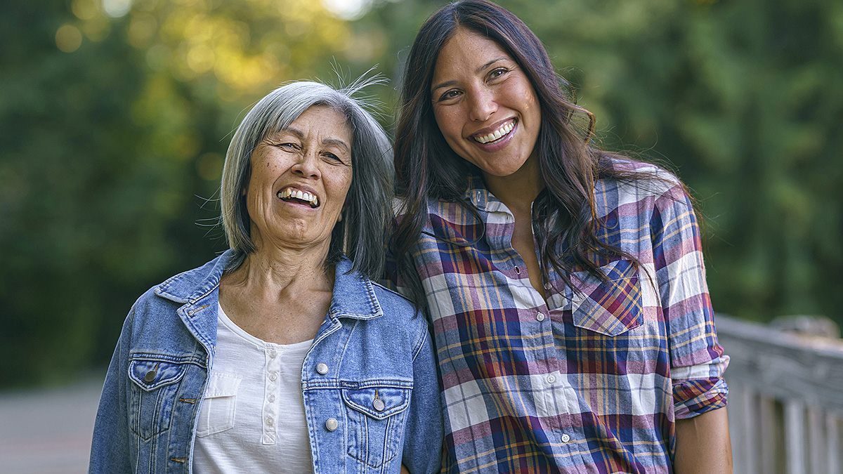 Mother and Daughter Mother and daughter smiling outdoors.