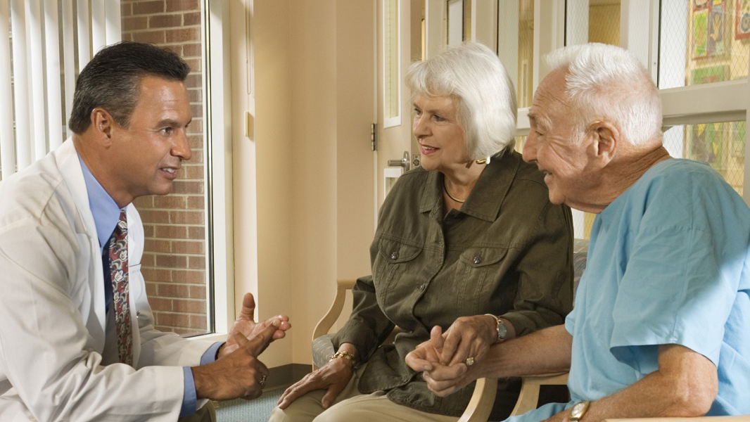 Doctor talking to couple Doctor speaking to an older couple