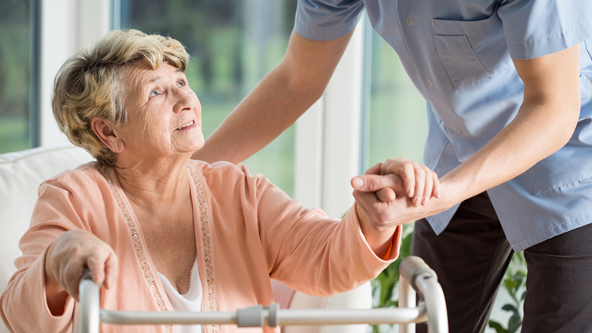 Older woman with walker Older woman with a walker getting help