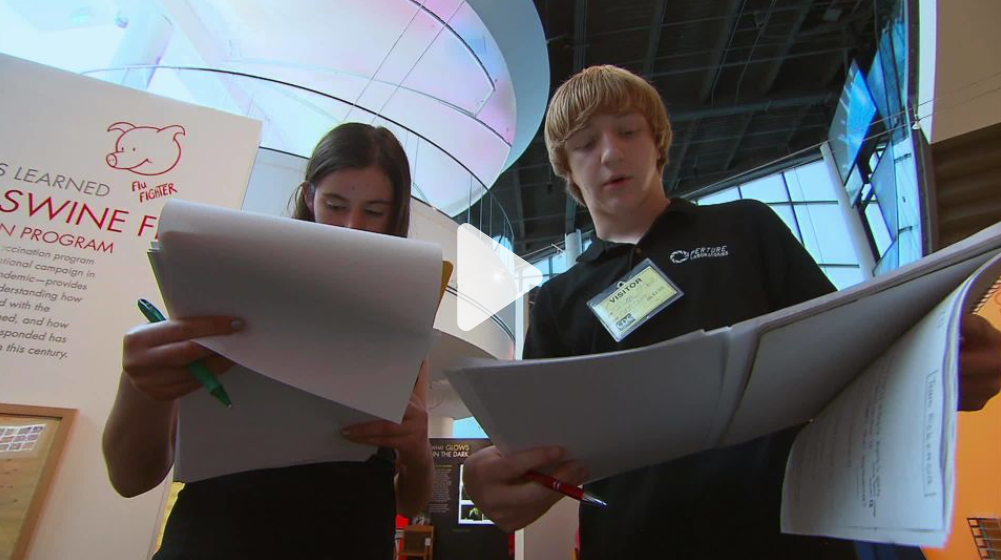 CDC-Camp-CNN two students examining documentation