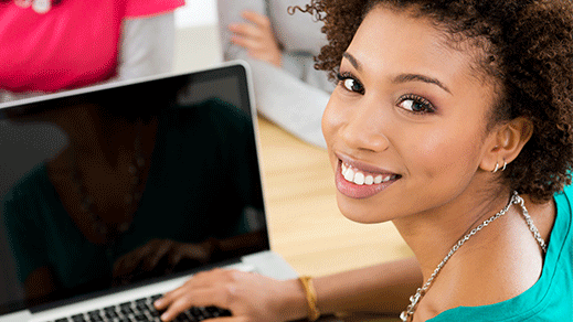 fellow-training-opps Young, Woman of Color using a laptop