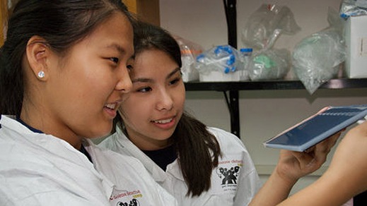 jdg_1053 two young, asian women looking at a medical device