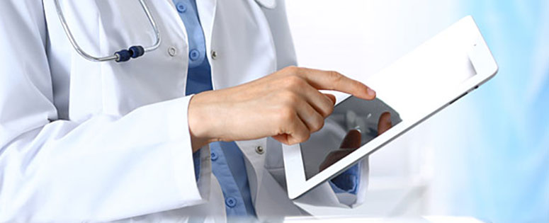 Doctor reviewing guidance on a tablet. Doctor reviewing guidance on a tablet.