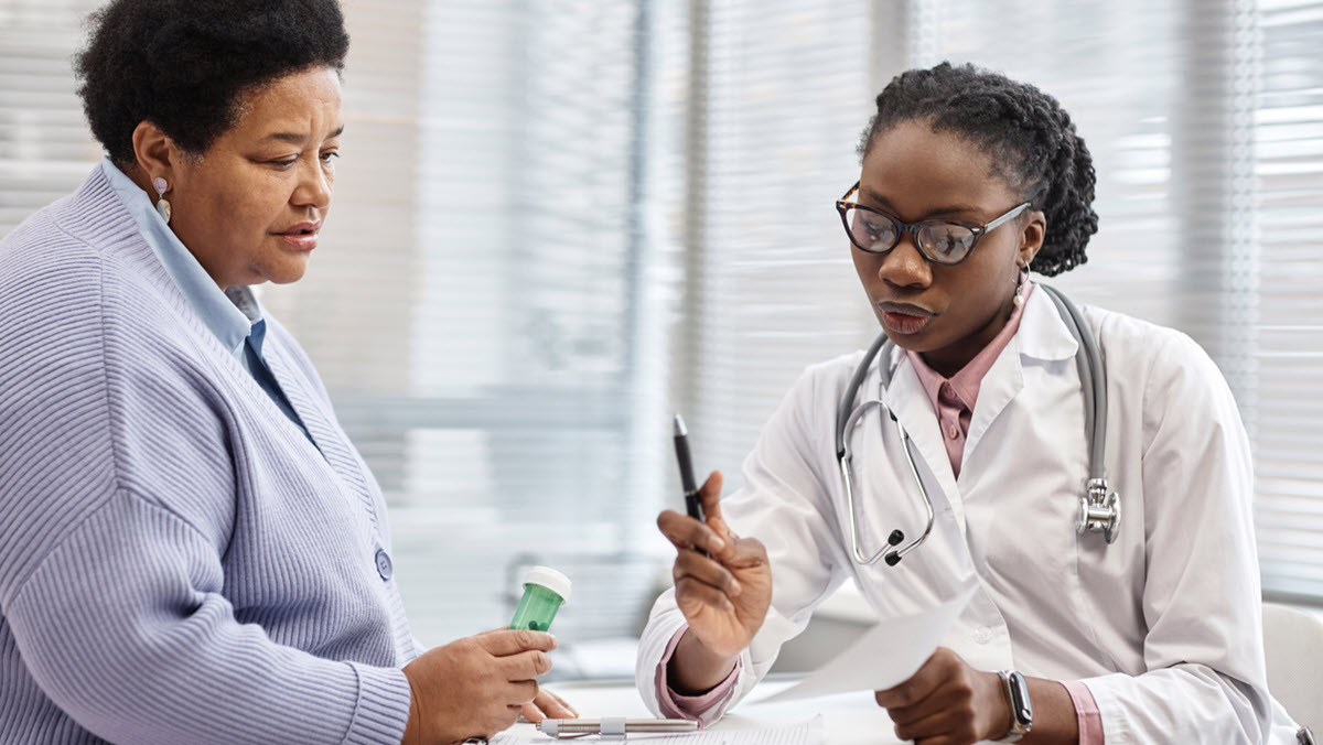 Doctor Showing Prescription to Female Patient