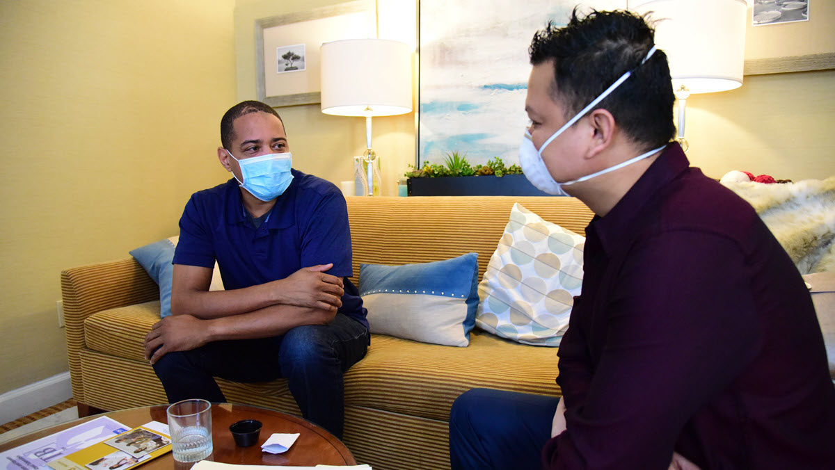 Health care provider conducting directly observed therapy A person with TB disease wearing a mask meets with a masked health care worker to receive TB treatment.