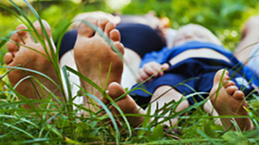 Bare feet Bare feet of a man and child in grass.