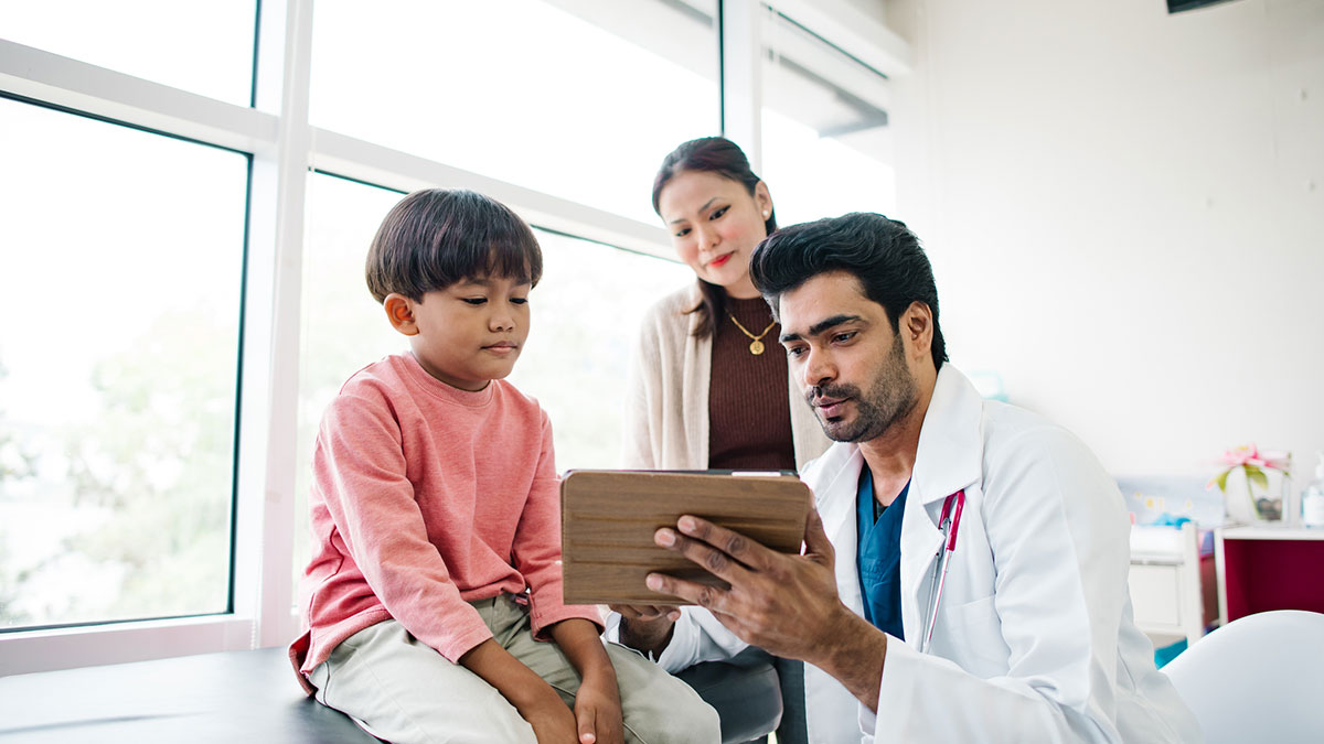 A young boy at the doctor with his mother A boy with his mother at a doctor visit