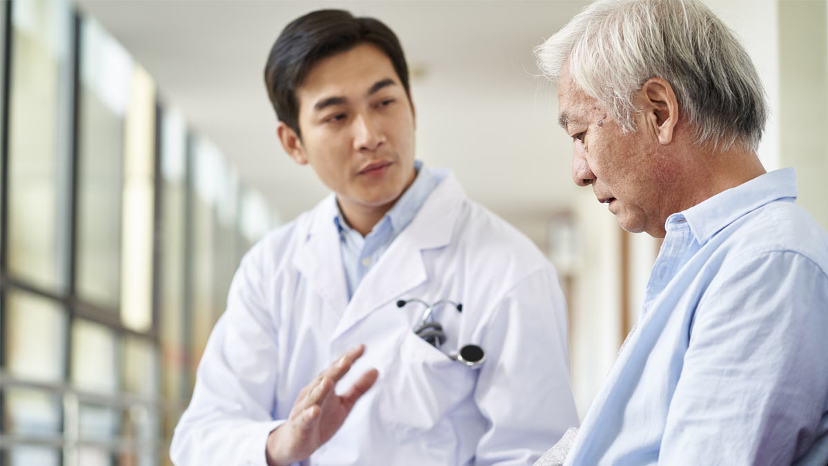 doctor-talking-to-man asian doctor talking to elderly man