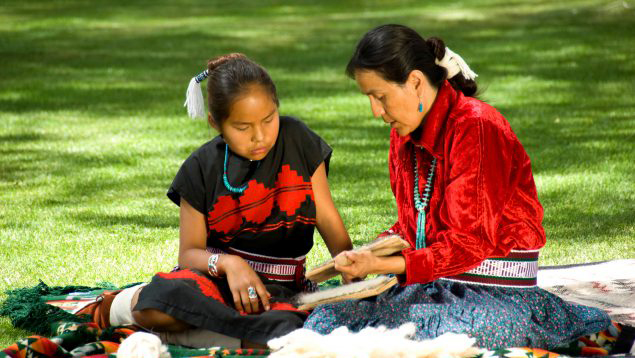 GettyImages119351081medium.jpg Native American adult and child sitting outside