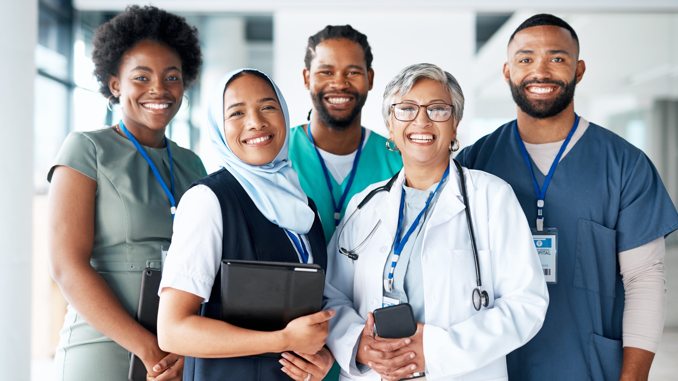 Clinicians A diverse group of healthcare providers standing together for a photo, representing different ages, races, and ethnicities.