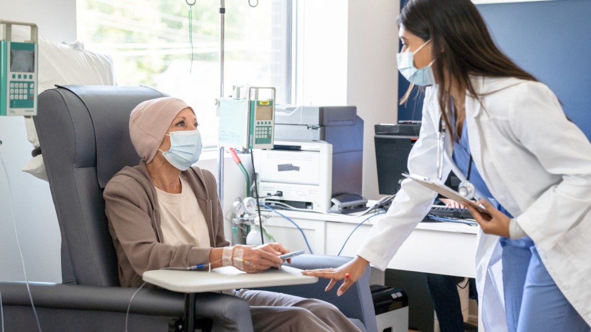 Hospital a nurse talking to a woman who is receiving chemotherapy