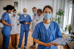 Reasons to vaccinate 5 Six healthcare workers together in a room talking.