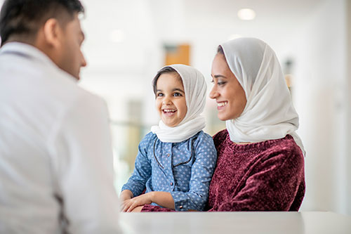 mother child checkup A mother and her daughter visiting a male health professional