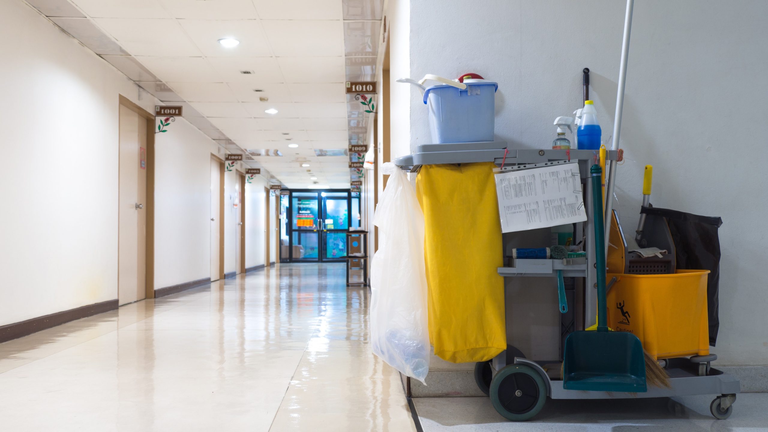 Hospital cleaning cart A cart covered in cleaning supplies is parked in a hospital hallway