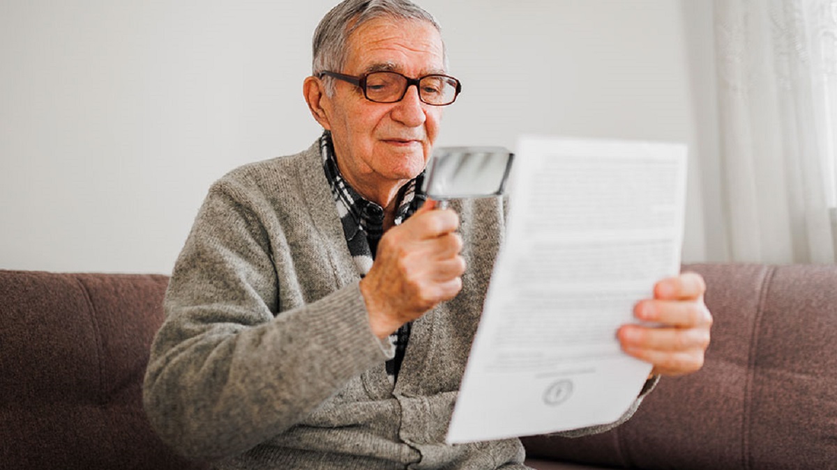 2-function-limitations-1200x675 Older man reading with a magnifying glass.