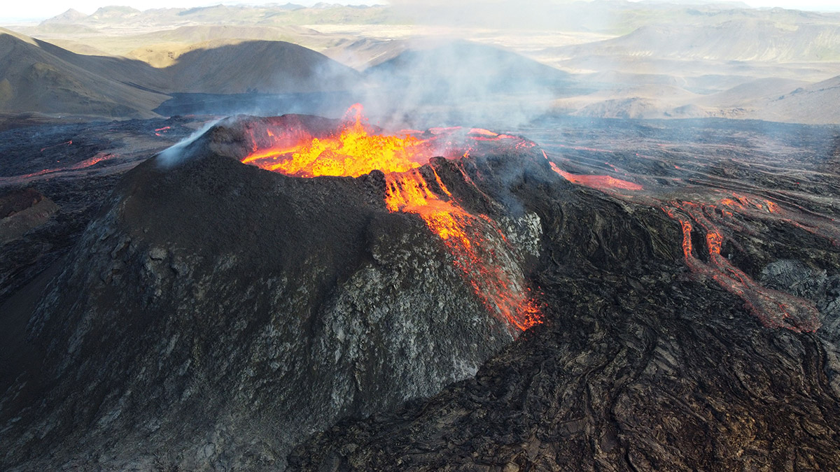 volcano crater Volcano with lava, ash, and gases spewing out.
