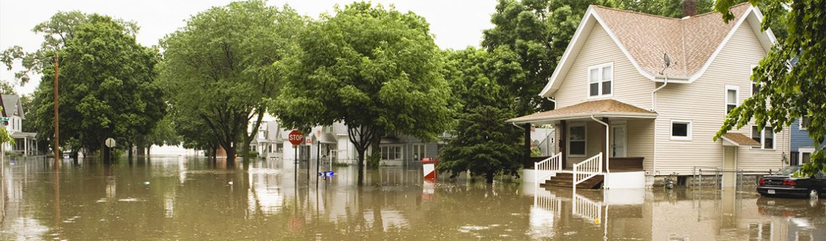 Emergency WASH flooding image A street with homes on it that is flooded after a natural disaster.