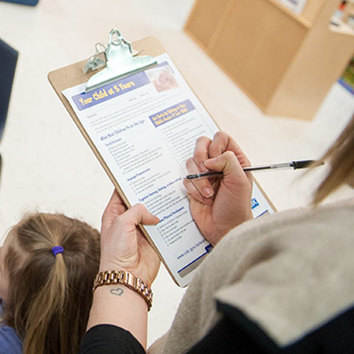 Your child at 5 yerars paperwork being filled out Your child at 5 yerars paperwork being filled out.