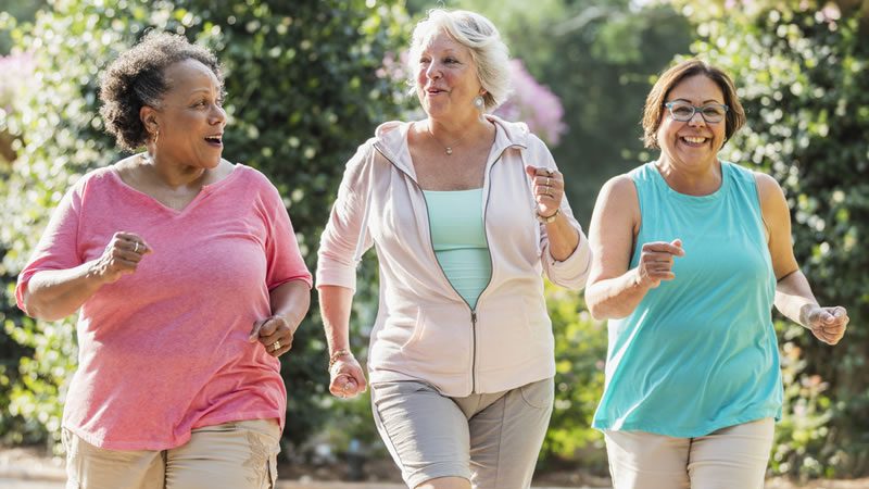 three women walking outside three women walking outside