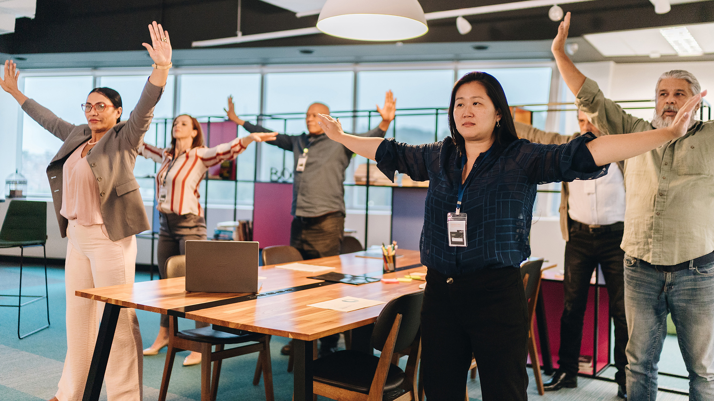 Workplace Health Stretching at Work Group of work colleagues group stretching at work.