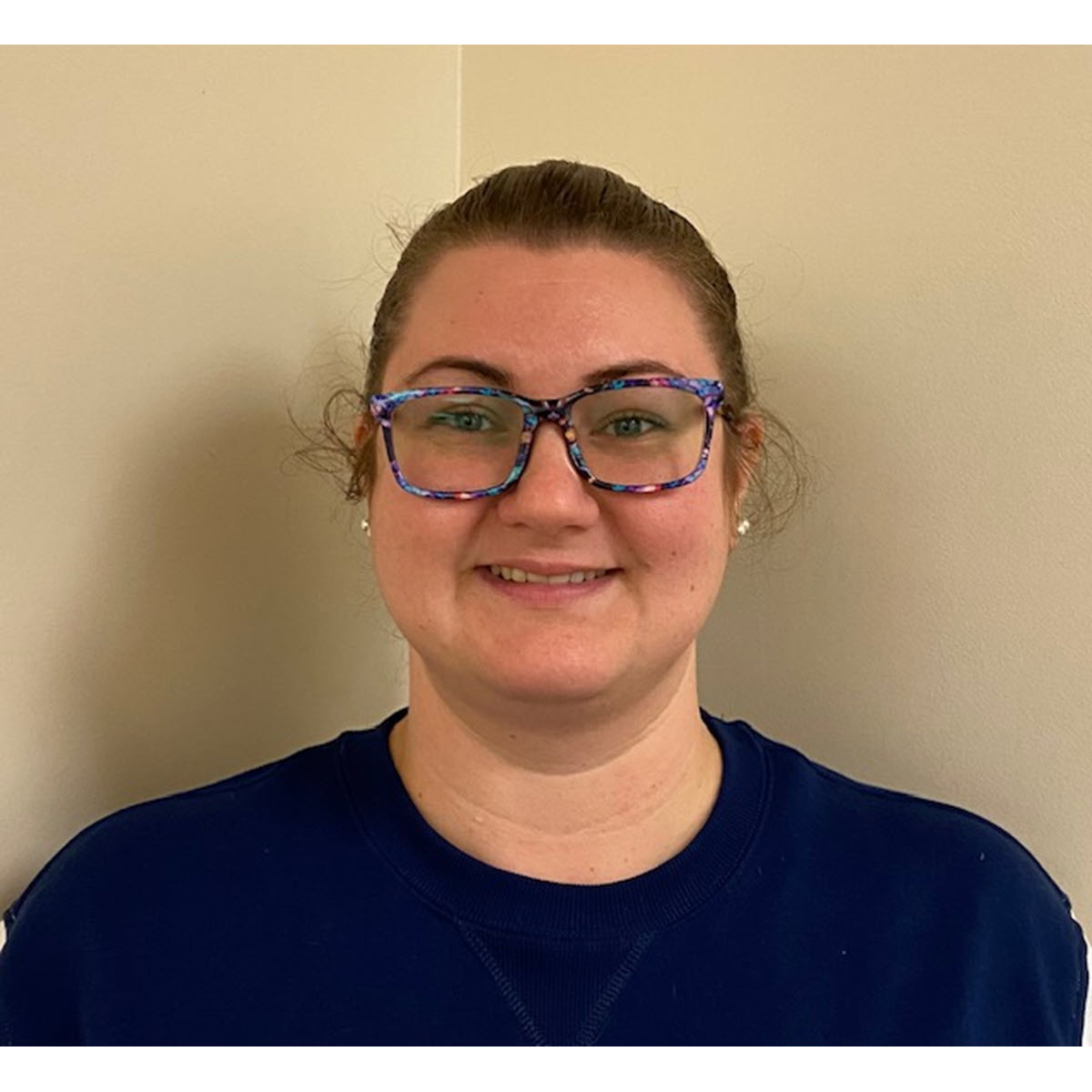 Brittany Bolin 2024 TB Champion Brittany Bolin smiling wearing colorful glasses and a blue shirt