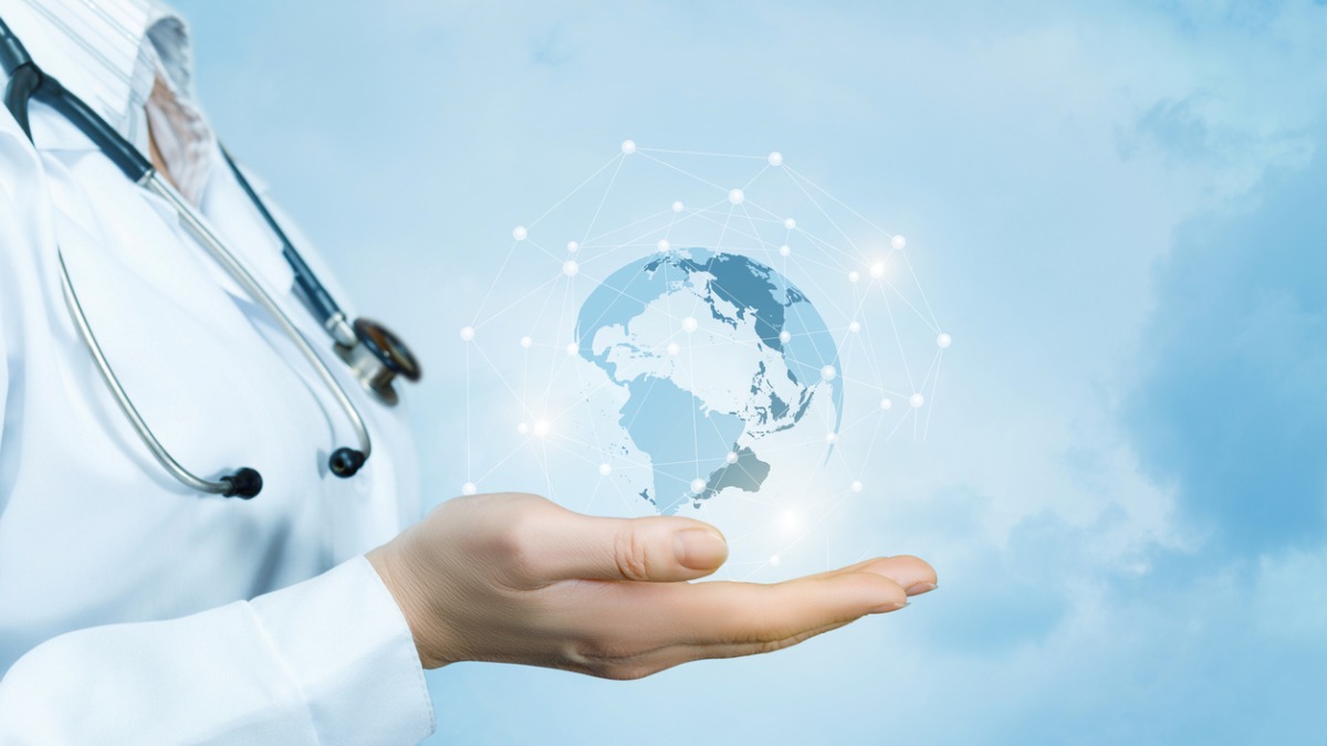 doctor global map 1200x675px A doctor holding a global map in their hand.