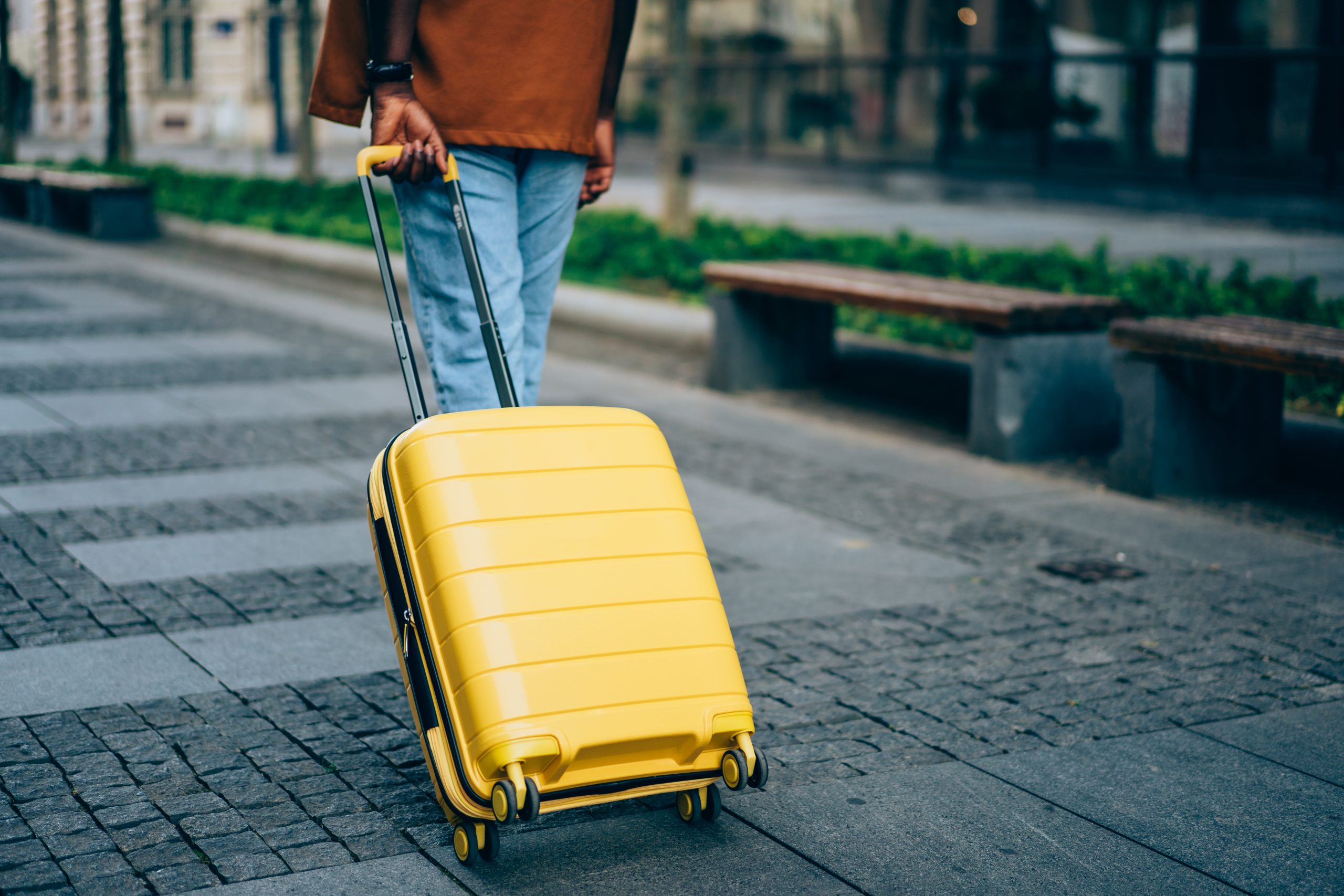 Traveler pulling a yellow case.