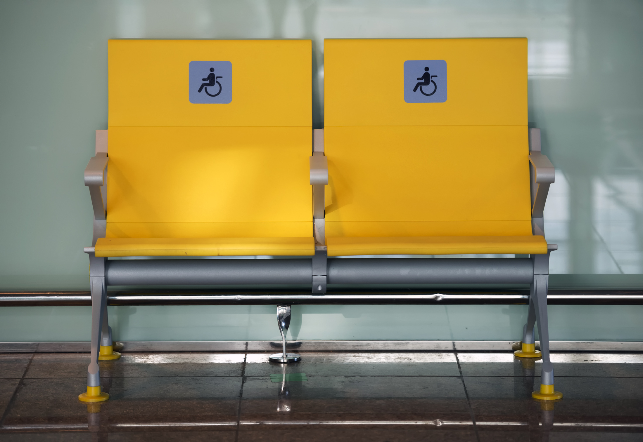 Two seats with a handicap symbol.