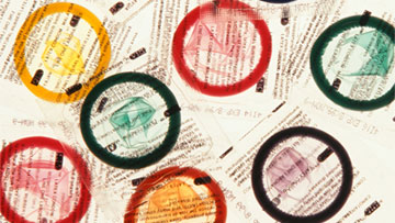 CAPs Different color condom packets.