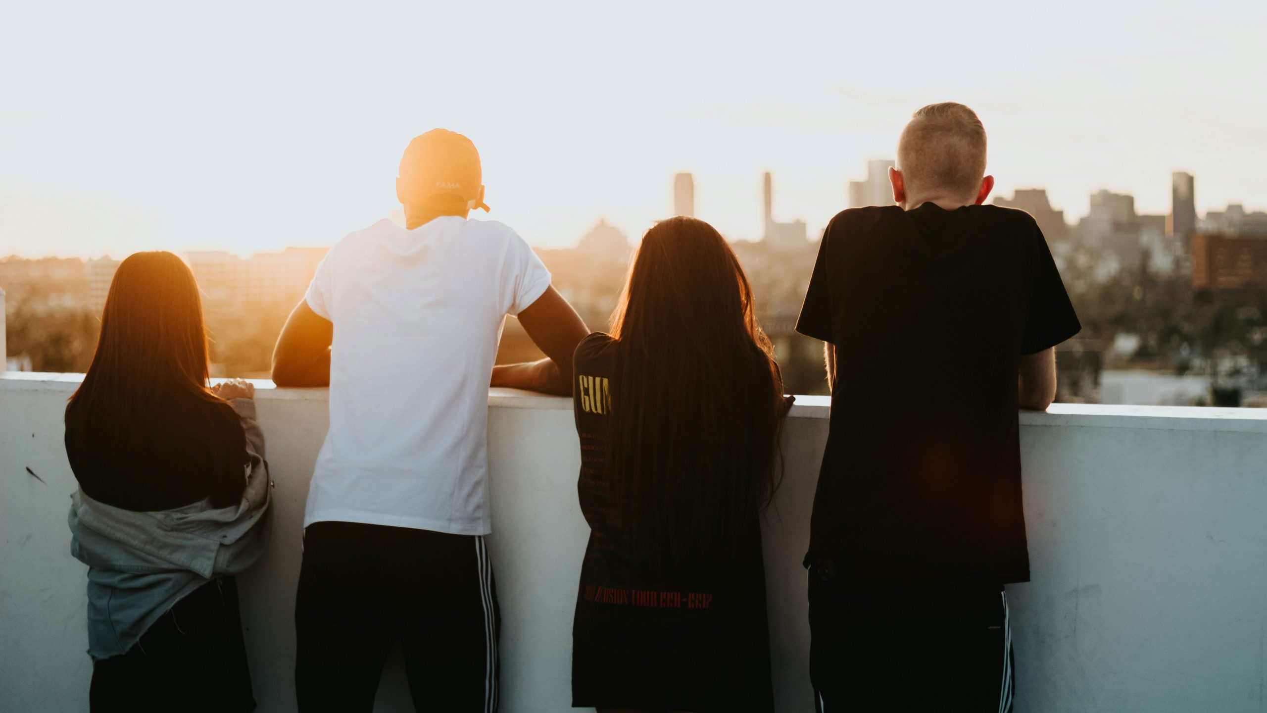 Substance use Youth standing on the deck of a tall building looking out into a city.