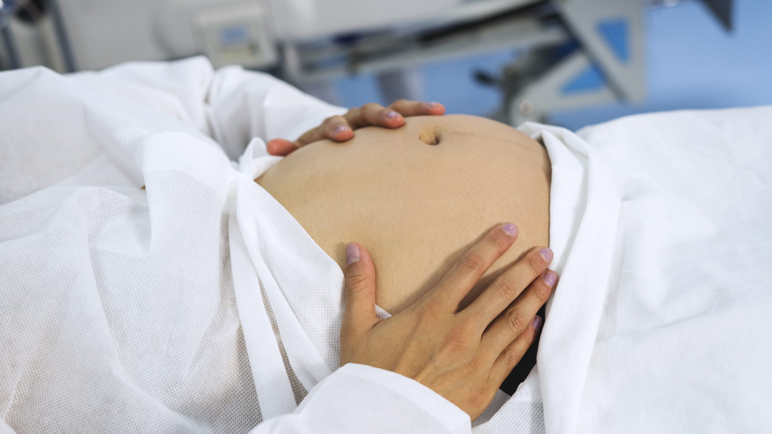 Pregnant woman holding her belly Pregnant woman holding her belly